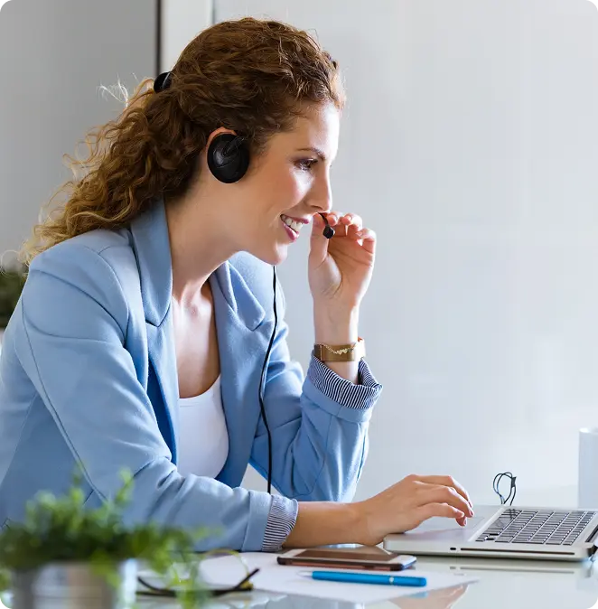 A Cert Success coordinator on a headset at her desk
